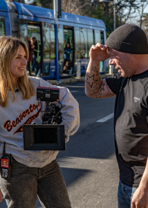 Camera operator and actor interacting on a location set